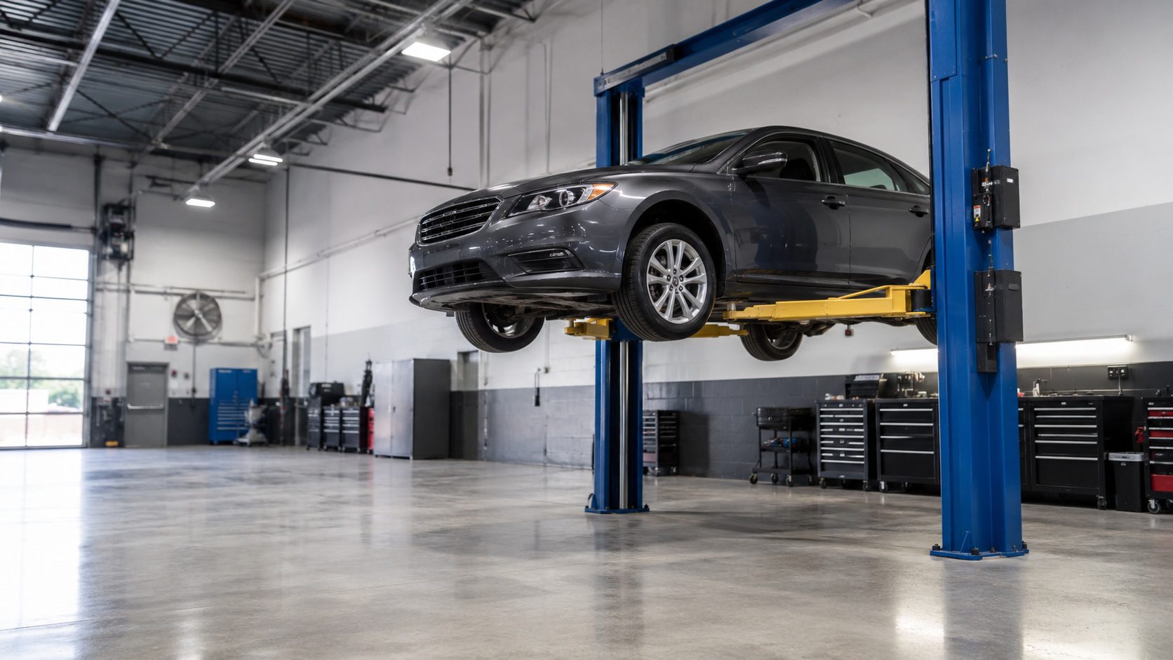 Car elevated in a modern auto repair shop.