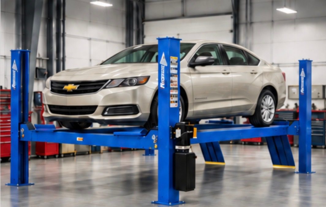 Car on hydraulic lift in auto shop.