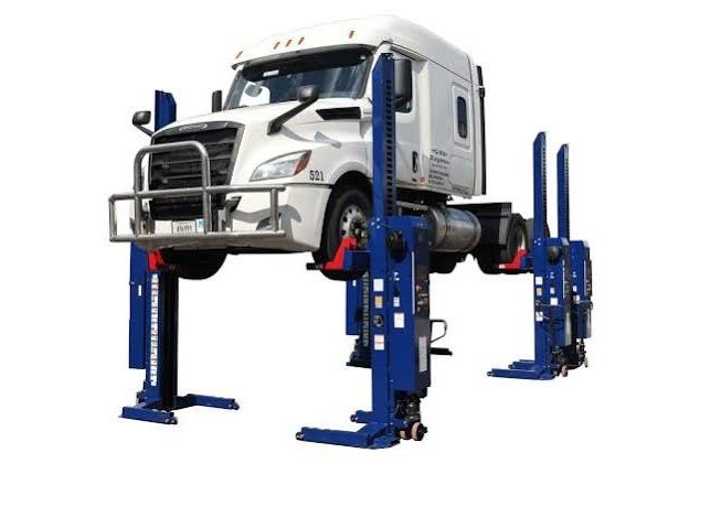 Truck elevated on hydraulic lift.